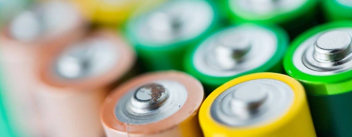 Close-up of colorful battery tops under a navy banner reading IP DECISIONS.