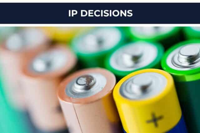 Close-up of colorful battery tops under a navy banner reading IP DECISIONS.